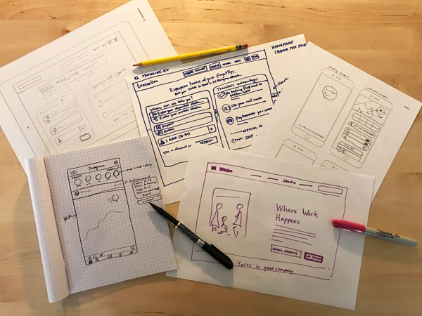 Different styles of wireframes using templates, graph paper and plain sheets of paper.