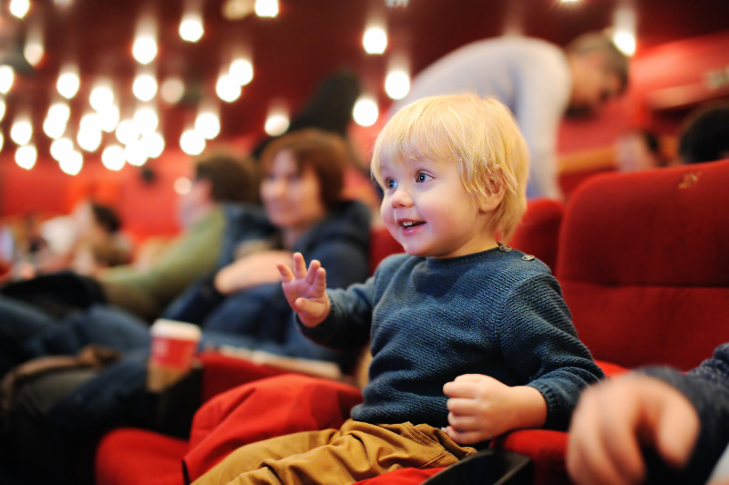 A child sitting in a cinema seat