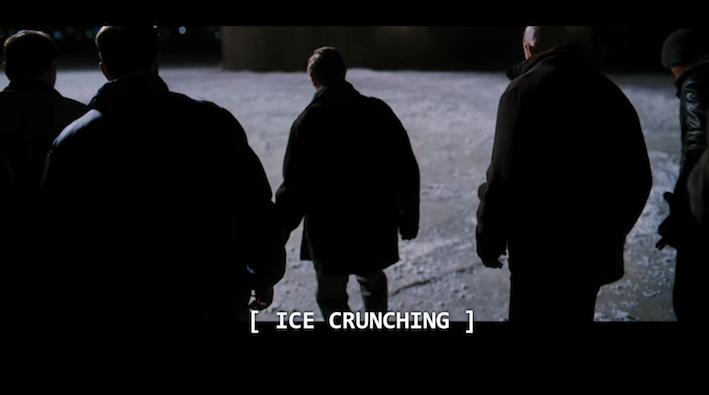 Group of men walking on ice. Closed captions read Ice Crunching, providing important details about the scene.