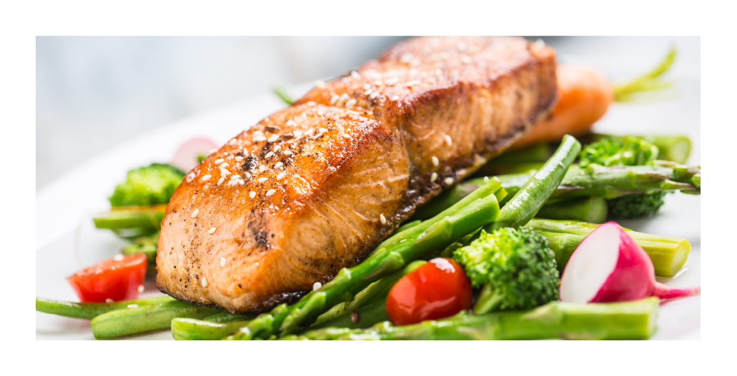 A photo of grilled salmon with asparagus, broccoli, cherry tomatoes and radishes.
