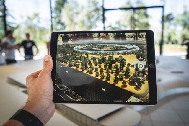 A virtual reality app on a tablet enables the learner to update the real world with additional information (Photo by Patrick Schneider on Unsplash)